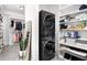 Functional laundry area within a spacious walk-in closet featuring stacked washer and dryer units at 4370 Freys Farm Nw Ln, Kennesaw, GA 30152