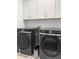 Laundry room with new appliances and custom white cabinets at 4370 Freys Farm Nw Ln, Kennesaw, GA 30152