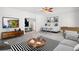 Bright living room featuring a bar, neutral colors, modern furniture, and hardwood-style flooring at 4370 Freys Farm Nw Ln, Kennesaw, GA 30152