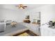 Bright living room with neutral colors, a modern ceiling fan, and an adjacent sitting area at 4370 Freys Farm Nw Ln, Kennesaw, GA 30152