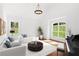 Bright living room with hardwood floors, large windows, white sofas, and a grand piano at 4370 Freys Farm Nw Ln, Kennesaw, GA 30152