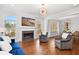 Cozy living room with a fireplace, large windows, and comfortable seating at 4370 Freys Farm Nw Ln, Kennesaw, GA 30152