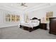 Luxurious main bedroom with a tray ceiling, large windows, and elegant furnishings at 4370 Freys Farm Nw Ln, Kennesaw, GA 30152