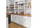 Well-organized pantry with custom shelving, butcher block countertop, and beverage cooler at 4370 Freys Farm Nw Ln, Kennesaw, GA 30152