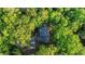 An aerial view of a home tucked away in a lush, green forest at 4614 Riveredge Cv, Snellville, GA 30039