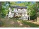 The back exterior of this home has a small deck and entry at ground level at 4614 Riveredge Cv, Snellville, GA 30039