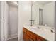 Bathroom with neutral-colored walls, a well-lit mirror, and a wood cabinet at 4614 Riveredge Cv, Snellville, GA 30039