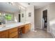 Bright bathroom features double vanity, large mirror, and separate tub at 4614 Riveredge Cv, Snellville, GA 30039
