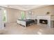 Serene main bedroom with a fireplace, neutral tones, and plenty of natural light at 4614 Riveredge Cv, Snellville, GA 30039