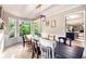 Charming dining area featuring a rustic table, statement lighting, and a view to the kitchen at 4614 Riveredge Cv, Snellville, GA 30039
