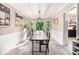 Elegant dining room with large windows, carpet flooring, and modern light fixture at 4614 Riveredge Cv, Snellville, GA 30039