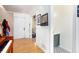 Hardwood entryway with a half bath and decorative wall art leading into the home at 4614 Riveredge Cv, Snellville, GA 30039