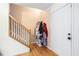 Bright entryway features hardwood floors, a staircase, and a convenient coat rack at 4614 Riveredge Cv, Snellville, GA 30039