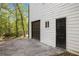 Side of house showing garage door, entrance door, and a partial driveway at 4614 Riveredge Cv, Snellville, GA 30039