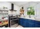 Charming kitchen boasts updated appliances, blue cabinets, and bright natural light at 4614 Riveredge Cv, Snellville, GA 30039