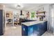 Well-lit kitchen features blue cabinets, functional island, modern appliances, and convenient open layout at 4614 Riveredge Cv, Snellville, GA 30039
