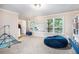Large open living area with big bean bag chair and views of the trees at 4614 Riveredge Cv, Snellville, GA 30039