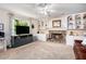 Bright living room featuring a stone fireplace, built-in shelves, and a large window at 4614 Riveredge Cv, Snellville, GA 30039