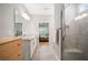 Well-lit bathroom boasts granite countertops, double sinks, glass shower with view into bedroom at 503 Forest Ln, Canton, GA 30114