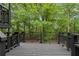 A black porch overlooks a forest providing ample privacy and scenery at 6659 Manoleta Dr, Lithonia, GA 30038