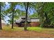 View of the backyard featuring a tiered deck and a home blending modern upgrades at 6659 Manoleta Dr, Lithonia, GA 30038
