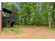 Expansive backyard featuring lush greenery and a multilevel deck connected to the home at 6659 Manoleta Dr, Lithonia, GA 30038