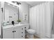 Well-lit bathroom with modern vanity, black accents, and a combined shower and tub at 6659 Manoleta Dr, Lithonia, GA 30038