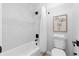Bright bathroom features a shower-tub combo with modern fixtures and marble-like tiles at 6659 Manoleta Dr, Lithonia, GA 30038