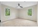 Cozy bedroom with neutral carpet and abundant natural light from large windows at 6659 Manoleta Dr, Lithonia, GA 30038