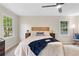Bright bedroom with ceiling fan, large windows, and beige carpet at 6659 Manoleta Dr, Lithonia, GA 30038