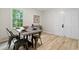 Bright eat-in dining room offering table with seating, natural light, and double doors at 6659 Manoleta Dr, Lithonia, GA 30038