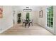 Bright dining room features updated light fixture, flooring, and views of the outdoors at 6659 Manoleta Dr, Lithonia, GA 30038