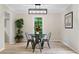 Bright dining room features updated light fixture, flooring, and views of the outdoors at 6659 Manoleta Dr, Lithonia, GA 30038