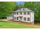Inviting two-story home features white siding, dark shutters, and a welcoming front entrance at 6659 Manoleta Dr, Lithonia, GA 30038