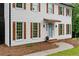 Close up of a charming two-story home featuring white siding and decorative shutters at 6659 Manoleta Dr, Lithonia, GA 30038