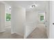 Upstairs hallway features carpet runner, neutral paint, and access to bedrooms at 6659 Manoleta Dr, Lithonia, GA 30038