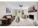 Cozy living room features a decorative fireplace, stylish furniture, and plenty of natural light at 6659 Manoleta Dr, Lithonia, GA 30038
