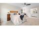 Bright main bedroom with ensuite bathroom, ceiling fan, and neutral paint at 6659 Manoleta Dr, Lithonia, GA 30038