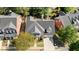 Charming two-story home features lush landscaping, a private front porch, two car garage, and inviting curb appeal at 1555 Heritage Trl, Roswell, GA 30075