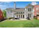 Charming home exterior highlighting a patio, lush lawn, and serene backyard retreat with tasteful patio furnishings at 1555 Heritage Trl, Roswell, GA 30075