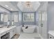 Luxurious bathroom with freestanding tub, double vanity, and frameless shower at 1555 Heritage Trl, Roswell, GA 30075