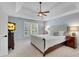Primary bedroom suite with tray ceilings, plantation shutters, and a ceiling fan at 1555 Heritage Trl, Roswell, GA 30075
