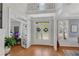 Bright foyer with hardwood floors and open access to the office and dining room at 1555 Heritage Trl, Roswell, GA 30075
