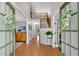 Inviting foyer showcasing hardwood floors, a staircase, and a view into other rooms at 1555 Heritage Trl, Roswell, GA 30075