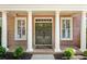 Elegant entryway featuring a brick facade, white columns, and double doors with wreaths at 1555 Heritage Trl, Roswell, GA 30075
