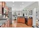 Bright kitchen with granite countertops, stainless steel appliances, and wood floors at 1555 Heritage Trl, Roswell, GA 30075