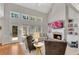Bright living room featuring fireplace, tall windows, and built-in shelving at 1555 Heritage Trl, Roswell, GA 30075