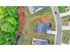 An aerial view showcases a modern home with a neatly manicured lawn and driveway on a sunny day at 3180 Andover St, Cumming, GA 30028