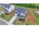 Aerial view of a well-landscaped home with a long driveway and lush green lawn at 3180 Andover St, Cumming, GA 30028