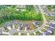 Aerial view captures a neighborhood featuring well-maintained homes, lush greenery, and a serene pond at 3180 Andover St, Cumming, GA 30028